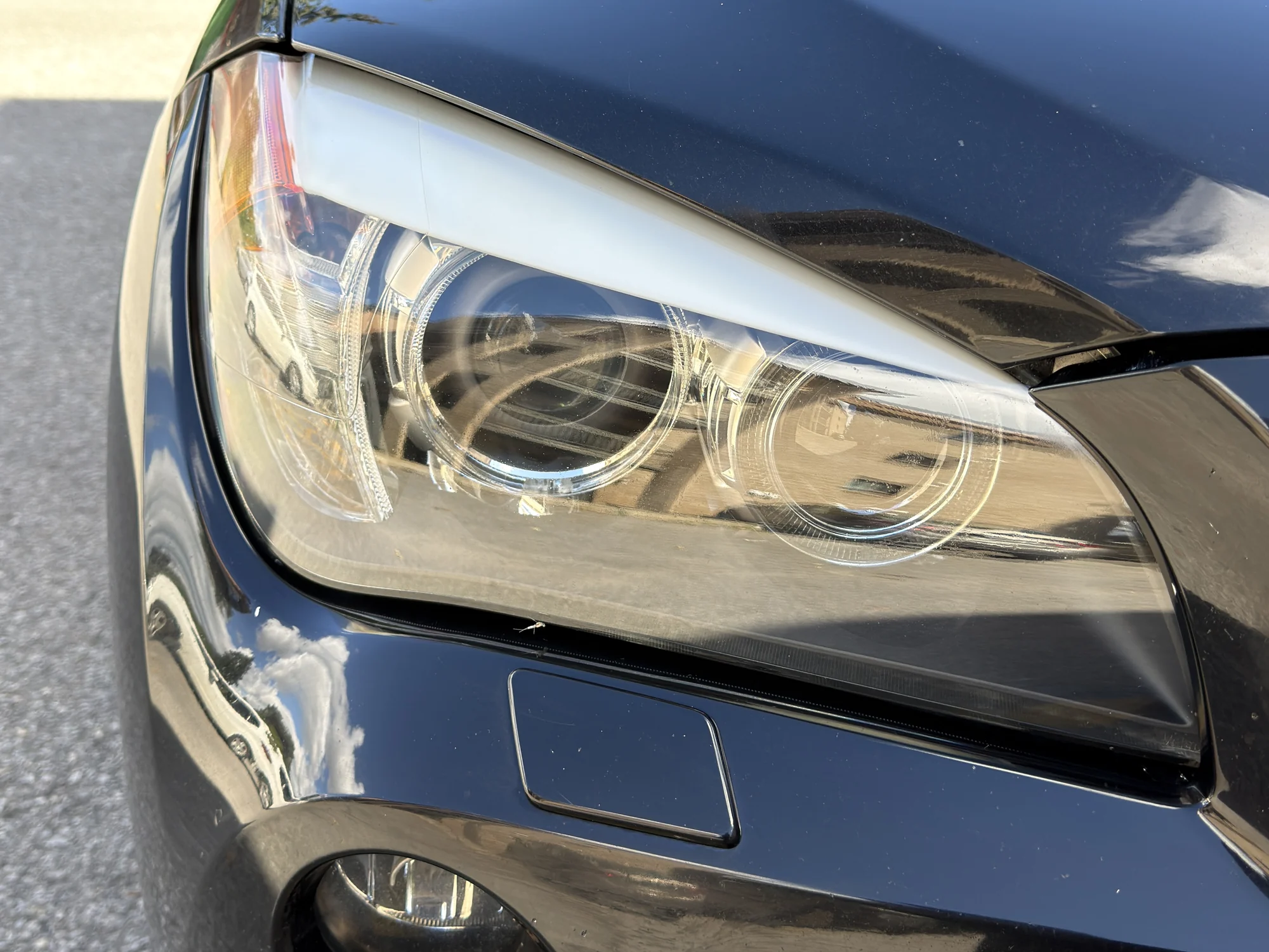 Clear and shiny BMW X1 headlight after restoration