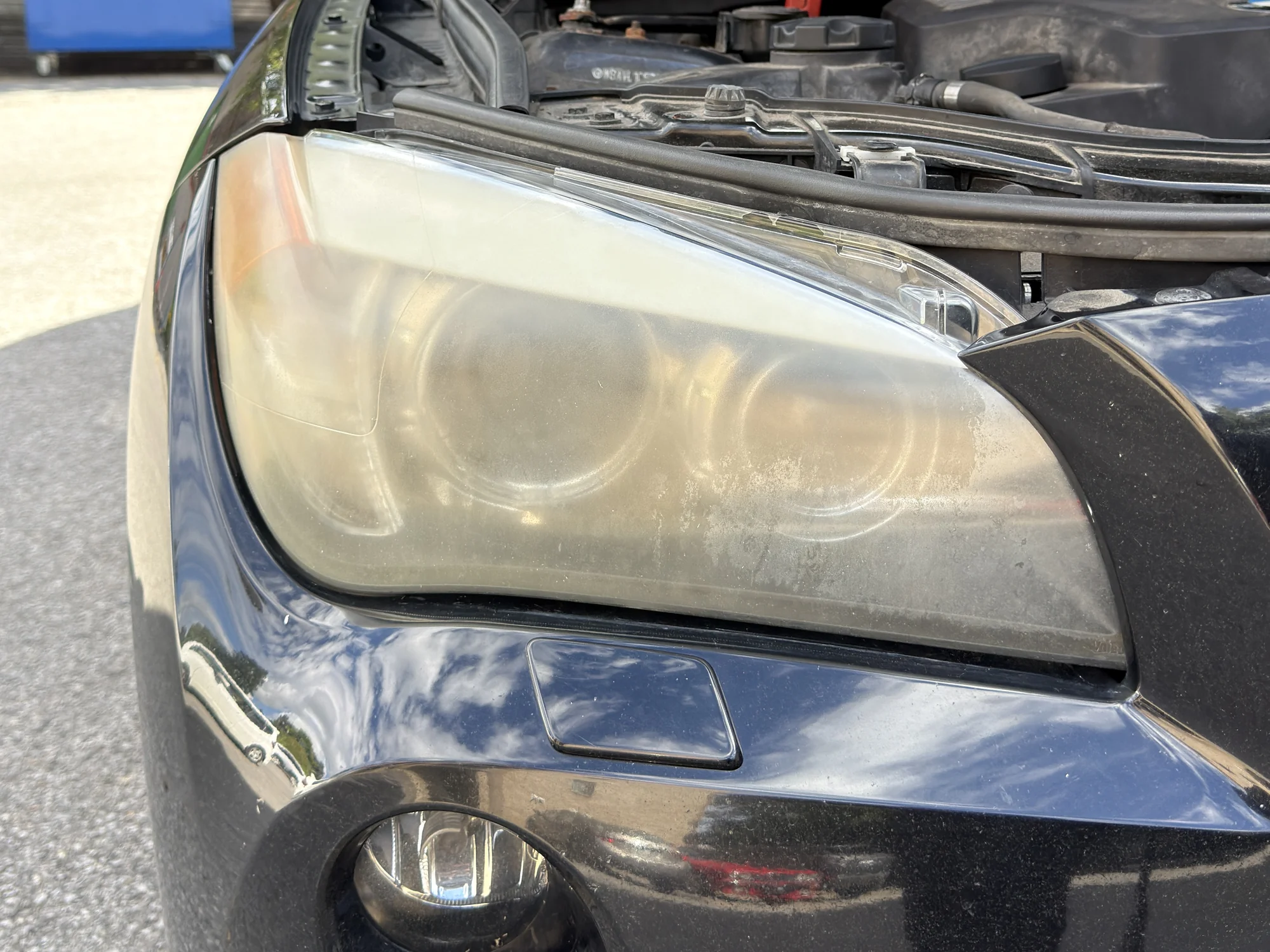Cloudy and yellowed BMW X1 headlight before restoration