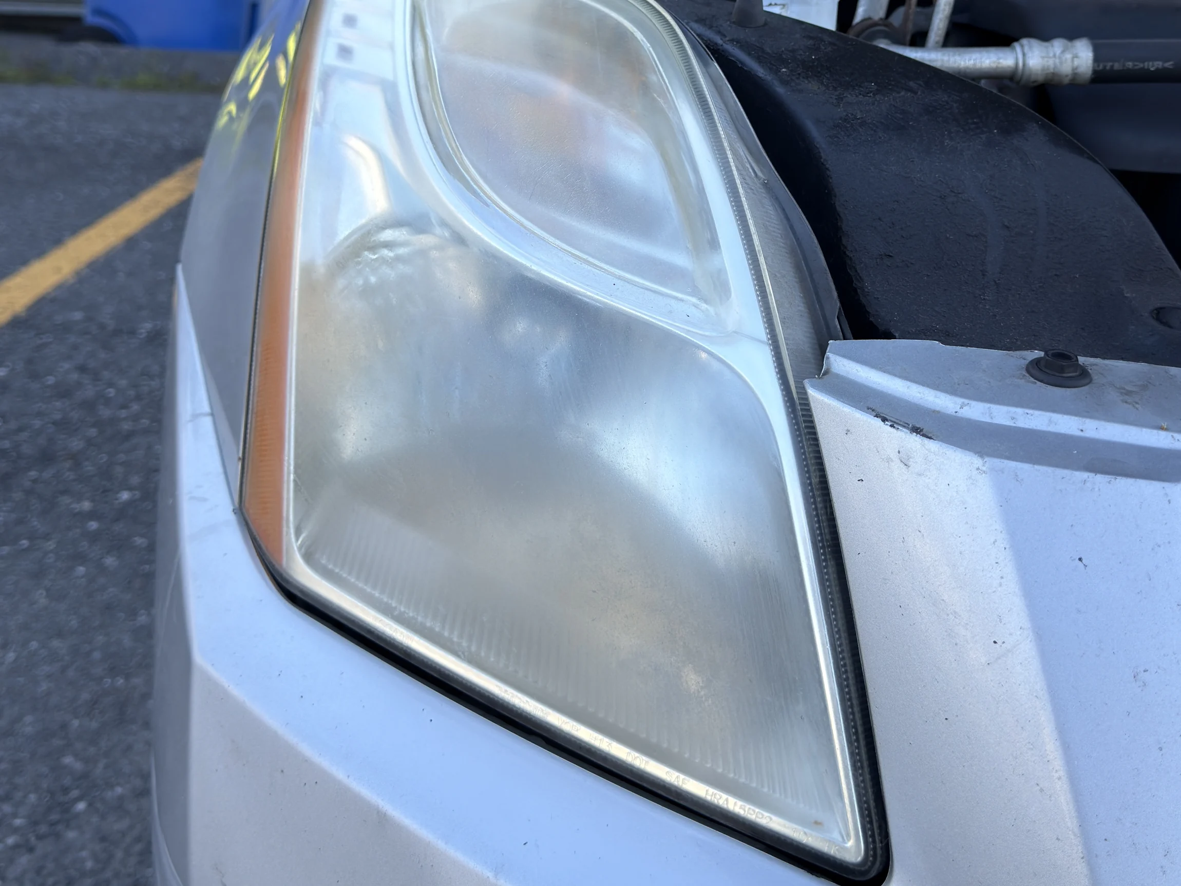 Nissan Sentra headlight before restoration — cloudy and yellowed