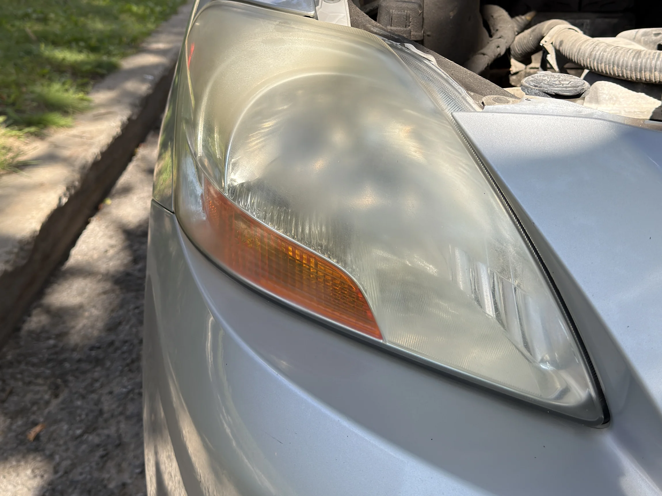 Toyota Yaris headlight before restoration — cloudy and yellowed