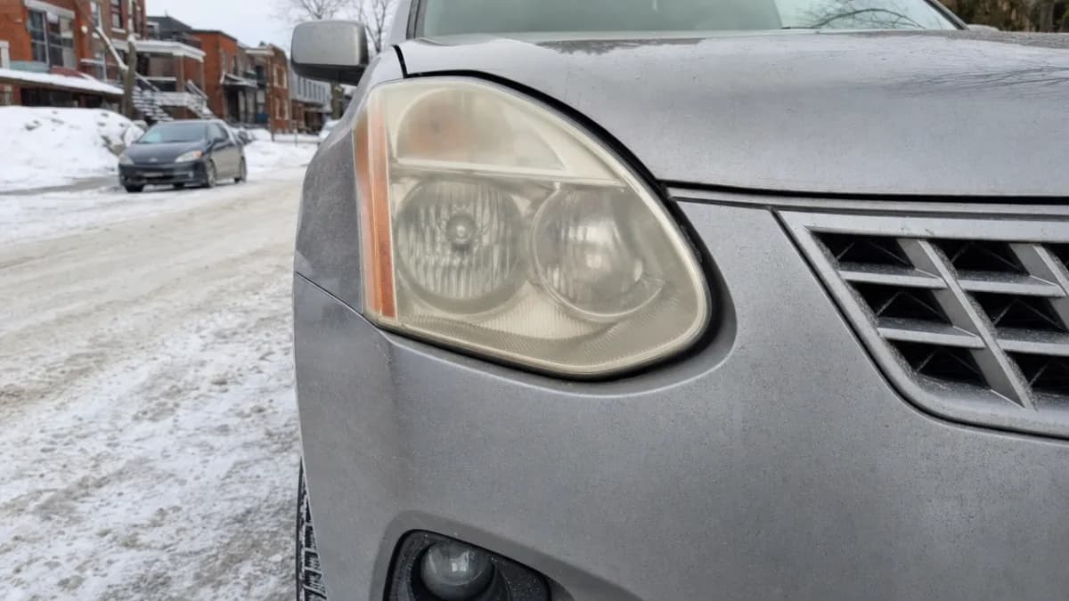 Yellowed and cloudy headlights on a Nissan Rogue parked on a Montreal street in winter